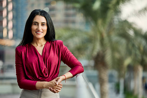 istock Smiling businesswoman leaning on railing 2218600822