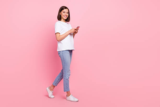 istock Full length body size view of attractive cheerful girl going using gadget web smm media multimedia isolated over pink pastel color background 2218600856