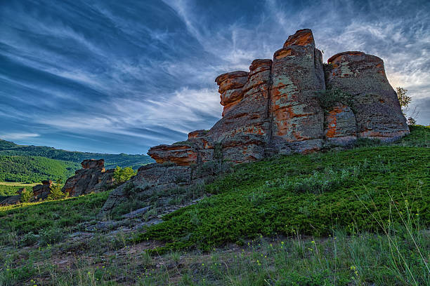 istock A large rock with numerous greenery around and incredibly beautiful clouds with the smallest details. Kazakh expanses, Ku Egendybulak mountains. Summer autumn landscape 2218603205