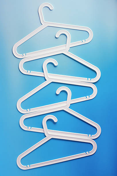 istock White Clothes hangers as creative minimal composition gradient background of blue color, Plastic racks creating modern and geometric aesthetic, top view photo vivid color, creative modern pattern 2218603875