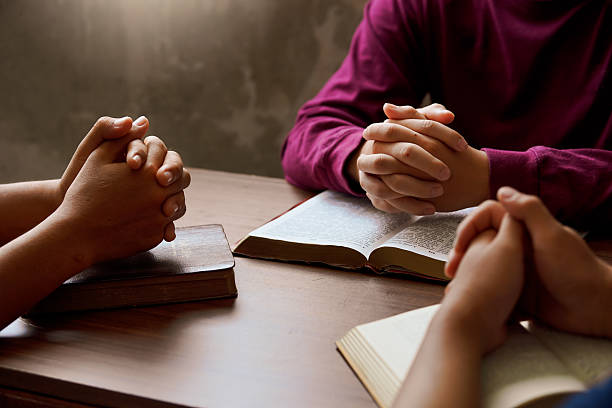 istock “Group Bible study with hands in prayer, reflecting spiritual connection, community, and meditation.” 2218605012