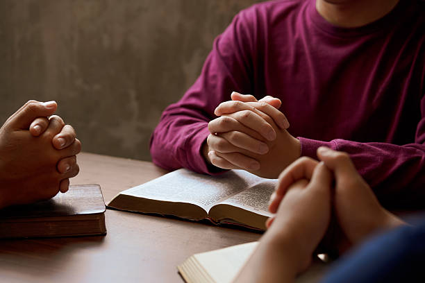 istock “Group Bible study with hands in prayer, reflecting spiritual connection, community, and meditation.” 2218605019