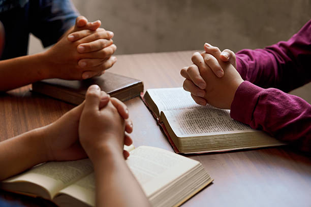 istock “Group Bible study with hands in prayer, reflecting spiritual connection, community, and meditation.” 2218605041