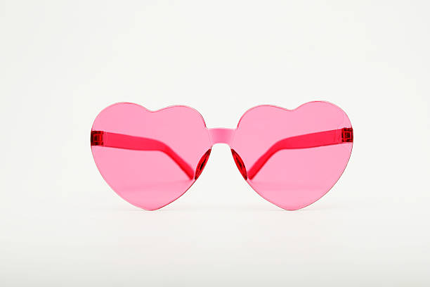 istock Pink heart shaped sunglasses resting on white background 2218605690