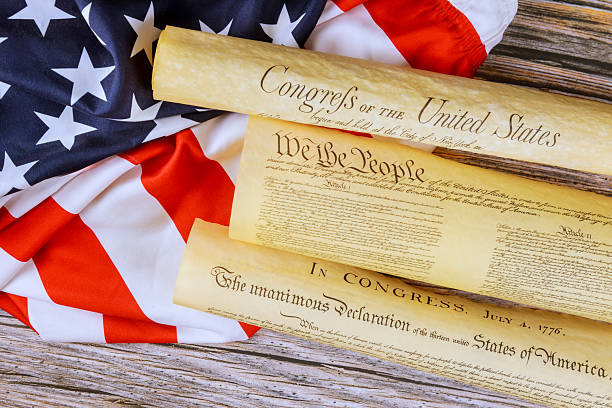 istock Historical documents representing founding principles of United States on flag backdrop 2218608372