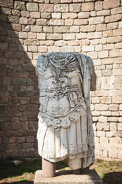 istock Ancient Roman statue torso in military armor displayed against stone wall at Pergamon archaeological site 2218609382