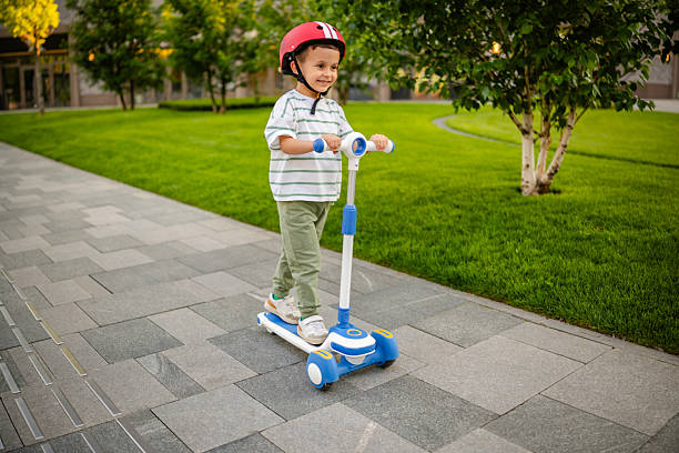 istock Boy Cruising on His Scooter Outdoors 2218609458