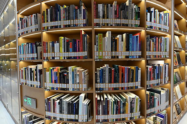 istock Endless rows of colorful books neatly arranged on towering library shelves, creating a mesmerizing pattern of knowledge and stories waiting to be discovered in this quiet literary sanctuary. 2218610319