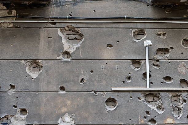istock An old wall, riddled with time and bullets, creates a dramatic texture filled with hidden histories and an atmosphere of abandonment. 2218610485