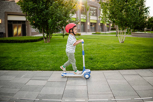 istock Confident Child Riding a Scooter 2218610591