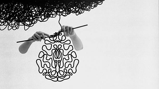 Unraveling Doubt. Brain almost complete but dark yarn trails off, symbolizing self-doubt, hesitation and fragile thoughts. Conceptual art collage. Concept of motivation, life coaching, wellness