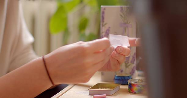 istock A person is handling a paper note with various craft supplies on a table 2218616234