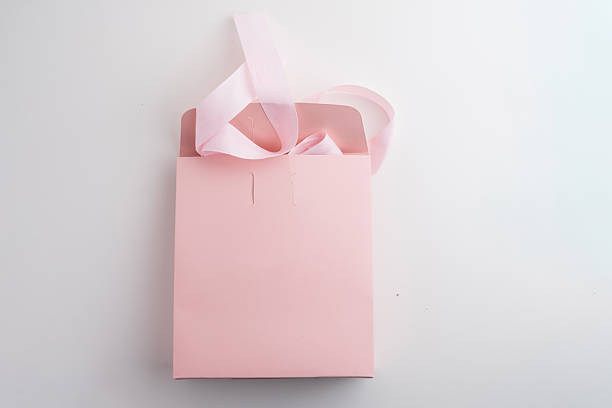 istock Pink box with pink ribbon on white background. Space for text and logo. Gift wrapping 2218618864