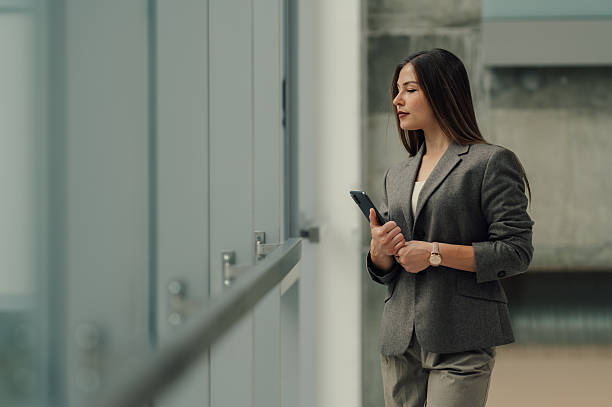 istock Businesswoman holding tablet and looking through office window 2218621444