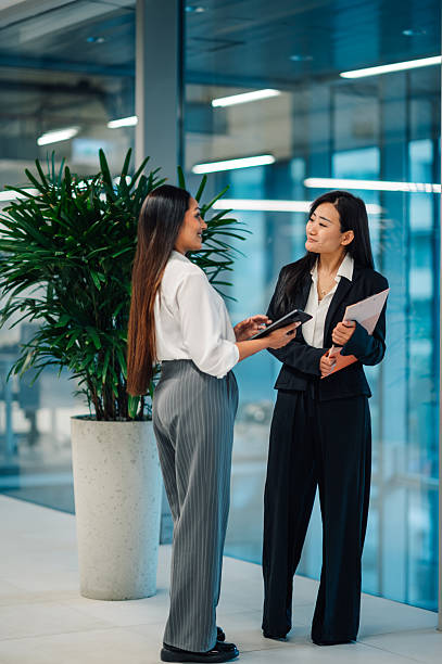 istock Two businesswomen collaborating using digital tablet in modern office 2218621481