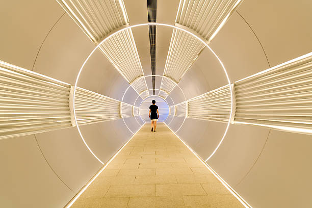 istock Woman walking in corridor tunnel 2218622241