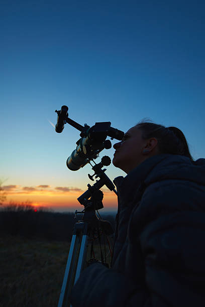 istock Amateur astronomer using telescope for watching stars, Moon, planets and other celestial objects from a field in nature. 2218623590