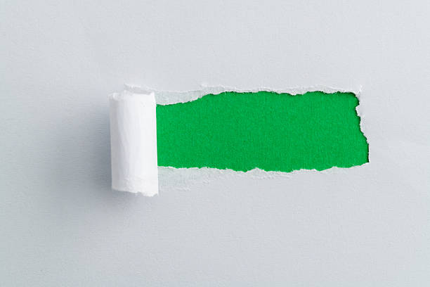istock White paper tearing a hole 2218623837