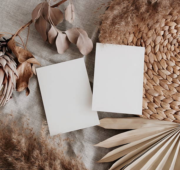 istock Card mockup empty blank paper and dry flowers in boho style background top view flat lay. Copy space. 2218624075