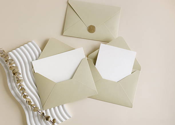 istock Beige envelopes with blank paper cards mockup inside top view, decor and dry eucalyptus branch 2218624251
