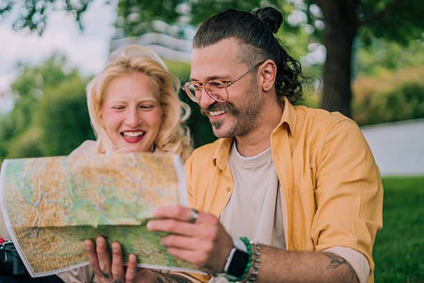 istock Two tourists study a city map while exploring their travel destination 2218624818