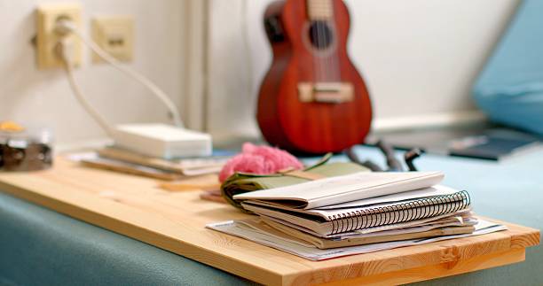 istock A Ukulele on a Table with Books and Stationery creates a cozy workspace 2218624911