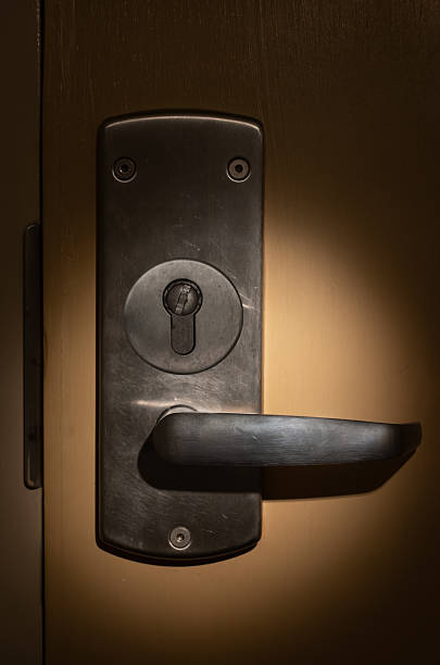 istock The light of the flashlight on the closed door lock 2218625512