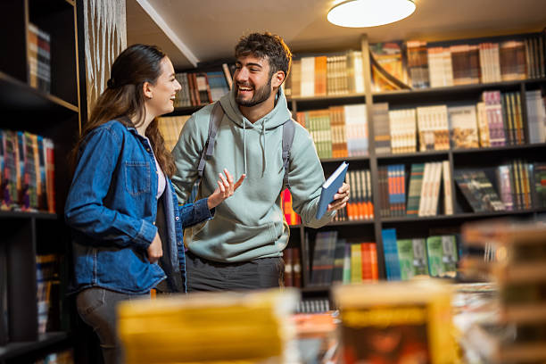 istock Male and Female Students Selecting Books in the Library 2218625610