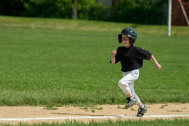 Baseball player, running and sports pitch with athlete with fast energy doing base run at game or match on a sport field. Fitness, exercise and training workout with sport runner male outdoor