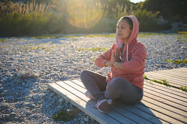 istock Woman Meditating Outdoors in Serene Setting While Enjoying Morning Calmness 2218629335