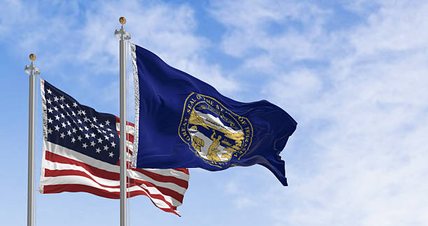 istock Nebraska state flag waving with the American flag 2218630135