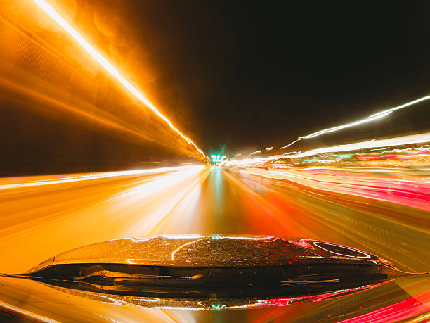 istock Car driving fast on a highway at night with motion blur effect 2218630586