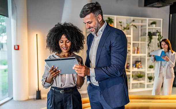 istock Business people working together on digital tablet in modern office lobby 2218631558