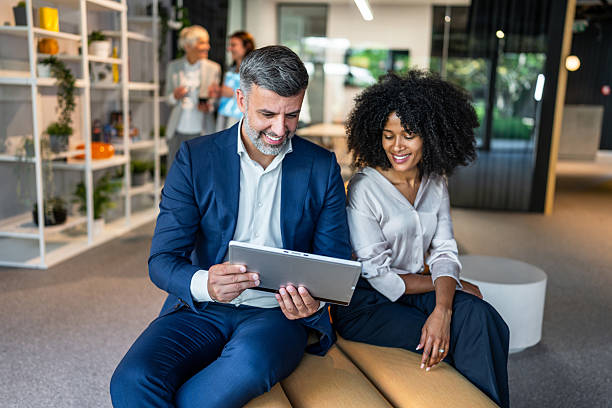 istock Business people working together on digital tablet in modern office lobby 2218632033