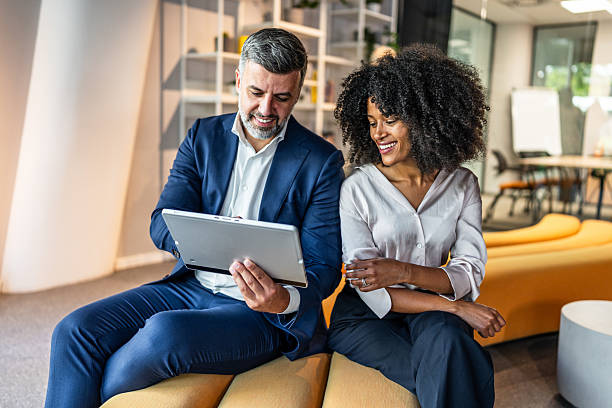 istock Business people working together on digital tablet in modern office lobby 2218632224