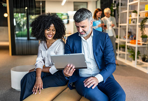 istock Business people working together on digital tablet in modern office lobby 2218632287