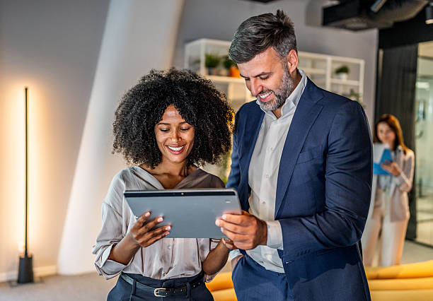 istock Business people working together on digital tablet in modern office lobby 2218632705
