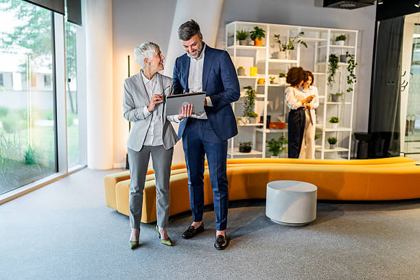 istock Business people using digital tablet in modern office lobby 2218632743