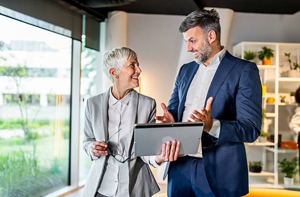 istock Business people using digital tablet in modern office lobby 2218632805