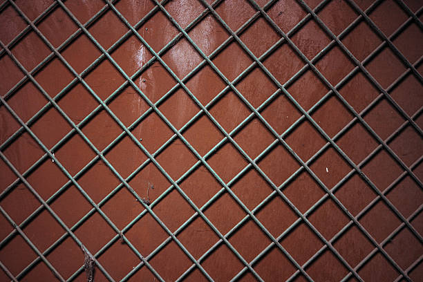 istock Metal cross bars on a wooden wall 2218632854