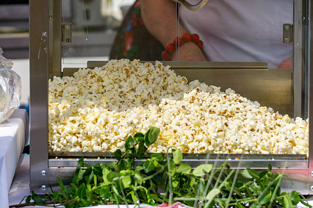Freshly made popcorn in a transparent machine at a festival