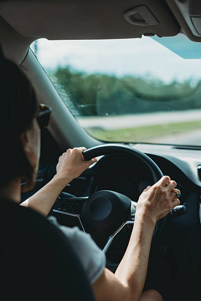istock Woman driving a car on a sunny day 2218636339