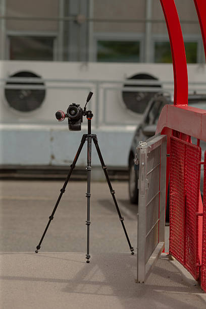 istock A tripodmounted camera beside a red barrier in an urban area 2218641049