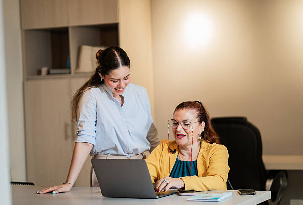 istock Teamwork: Young Woman and Senior Executive Collaborating on Digital Project 2218642074