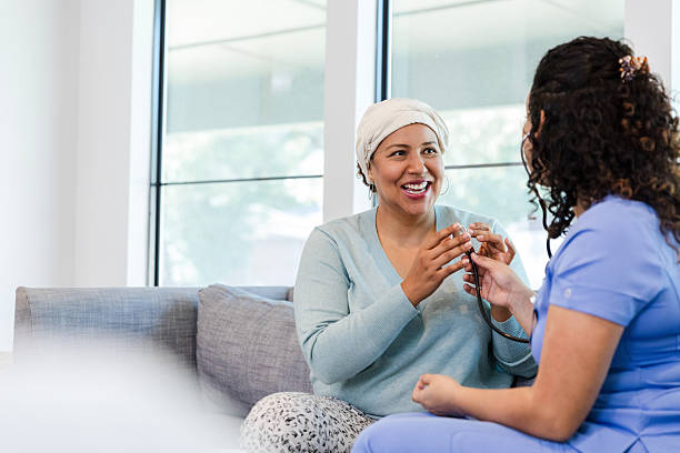 istock Cheerful Female Patient with Doctor During Home Visit 2218644257