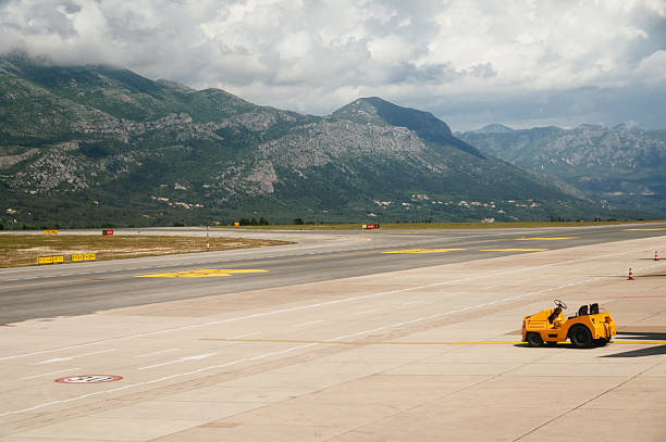 An airport taxiway with vehicles. Dubrovnik Airport, Croatia.