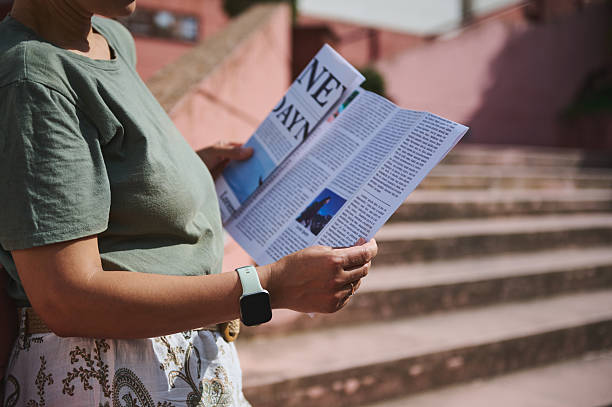 istock Person Reading a Newspaper Outdoors in a Relaxing and Serene Environment 2218646704