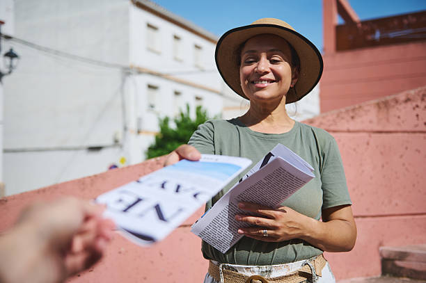 Smiling Woman Distributes Flyers in an Urban Outdoor Scene