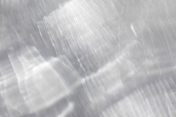 Neutral abstract shadows from pouring sunlight. Caustic background from light glare and shine reflection effects for product presentation.