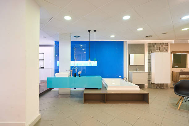 Wide shot of a modern bathroom showroom with various sanitary ware, fixtures, and a vibrant blue wall